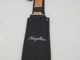 a close up of a knife in a black case on a white surface
