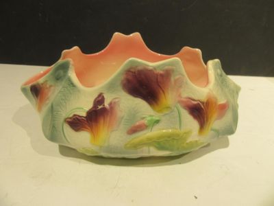 a small bowl with flowers painted on it on a table
