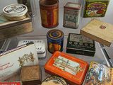 many different types of tins on a clear shelf