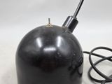 a black lamp that is on a table with a pair of scissors next to it