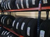 tires on a shelf in a store with a lot of them
