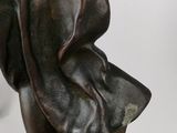 bronze statue of a woman holding a baby on a white background