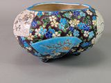 a vase that has been decorated with blue and white flowers