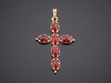 a gold cross with red stones on a black background