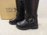 pair of black leather boots with buckles and a box in the background