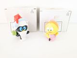 two figurines of cartoon characters in a box