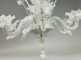 a glass chandelier that is hanging from the ceiling