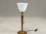 lamp with a white glass shade on a wooden base and a black cord