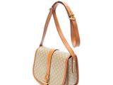 a beige and tan bag with a brown strap