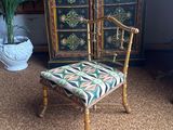 a chair that is sitting in front of a cabinet