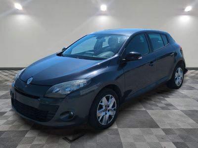 a gray car is parked in a room with a checkered floor