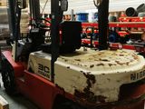 a forklift truck that is parked in a warehouse