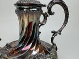 a silver vase that is sitting on a table