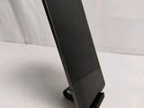 a tablet that is sitting on a stand on a table