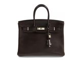 a brown leather handbag with a key on the handle