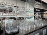 many glasses on the counter in the restaurant