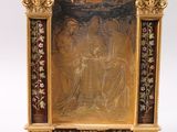a gold and black painting on the wall of a room