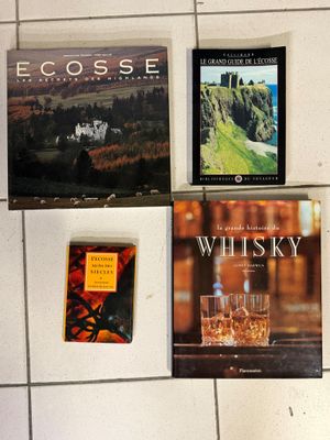 several books on a wall in a room with a white tiled floor