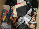 a cardboard box filled with clothes and other items