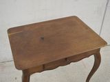 a small wooden table with a drawer underneath it