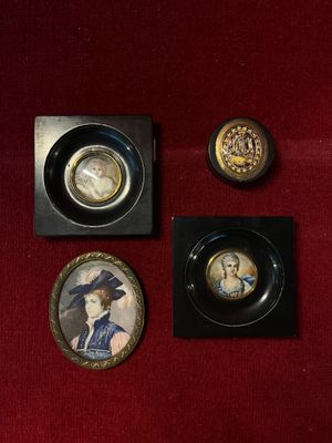 three miniature pictures of a woman in a hat and other items on a red cloth