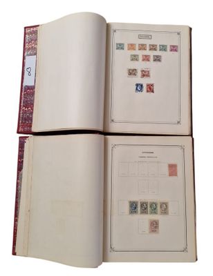 two pages of a book with stamps are open on a white surface