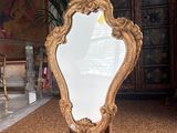 a mirror that is sitting on a stand in a room