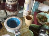 a glass table topped with bowls and bowls of food