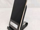 a cell phone that is on a stand on a table