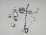 a lot of jewelry that is laying out on the table
