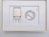 a white box with a charger and a cable in it