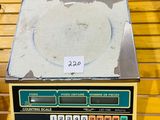 a scale that is sitting on a wooden table