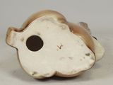 an antique figurine of a fish with a hole in it ' s mouth