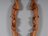 pair of carved wood candlesticks with flowers and leaves