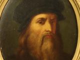 portrait d'un homme barbu coiffé d'un chapeau noir, dans un cadre doré
