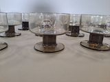 a lot of glasses sitting on a table with a white table cloth