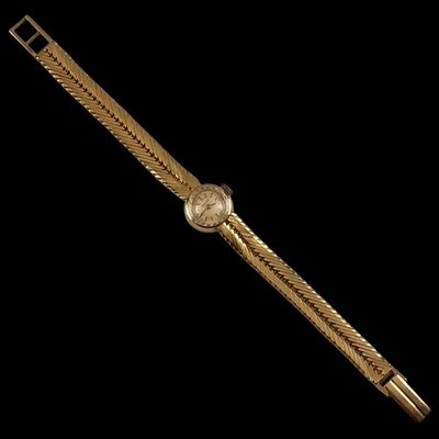 a gold watch on a black background with a black background