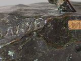 a bronze statue of a man riding a horse on a rock