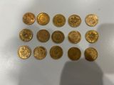a close up of a person ' s hand holding a bunch of gold coins