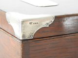 a close up of a wooden box with a metal lid