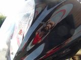 a close up of a motorcycle with a person taking a picture