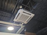 ceiling mounted air conditioner mounted to the ceiling of a building