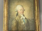 Un vieux tableau représentant un homme vêtu d'un manteau rayé est accroché au mur.
