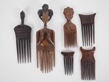 five wooden hair combs that are next to each other