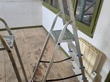 a ladder that is sitting on the floor in front of a window