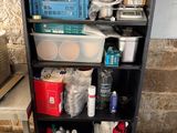 a black shelf with many containers and containers on it