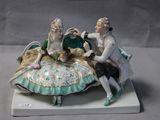 a figurine of a man and a woman sitting on a shell