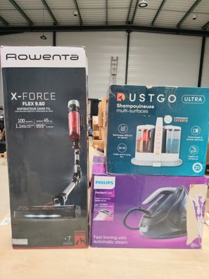 two boxes of vacuum cleaners sitting on a table in a warehouse