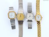 trois montres différentes et une montre en or sur un fond blanc