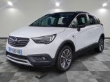 un SUV Opel blanc garé dans un garage au sol carrelé